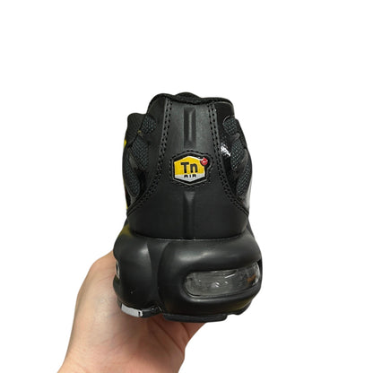 Luxury Chef Nike TN Air black sneakers with yellow Tn logo and visible air cushioning.