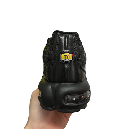 Luxury Chef Nike TN Air black leather sneakers with visible air cushioning and yellow Tn Air logo.