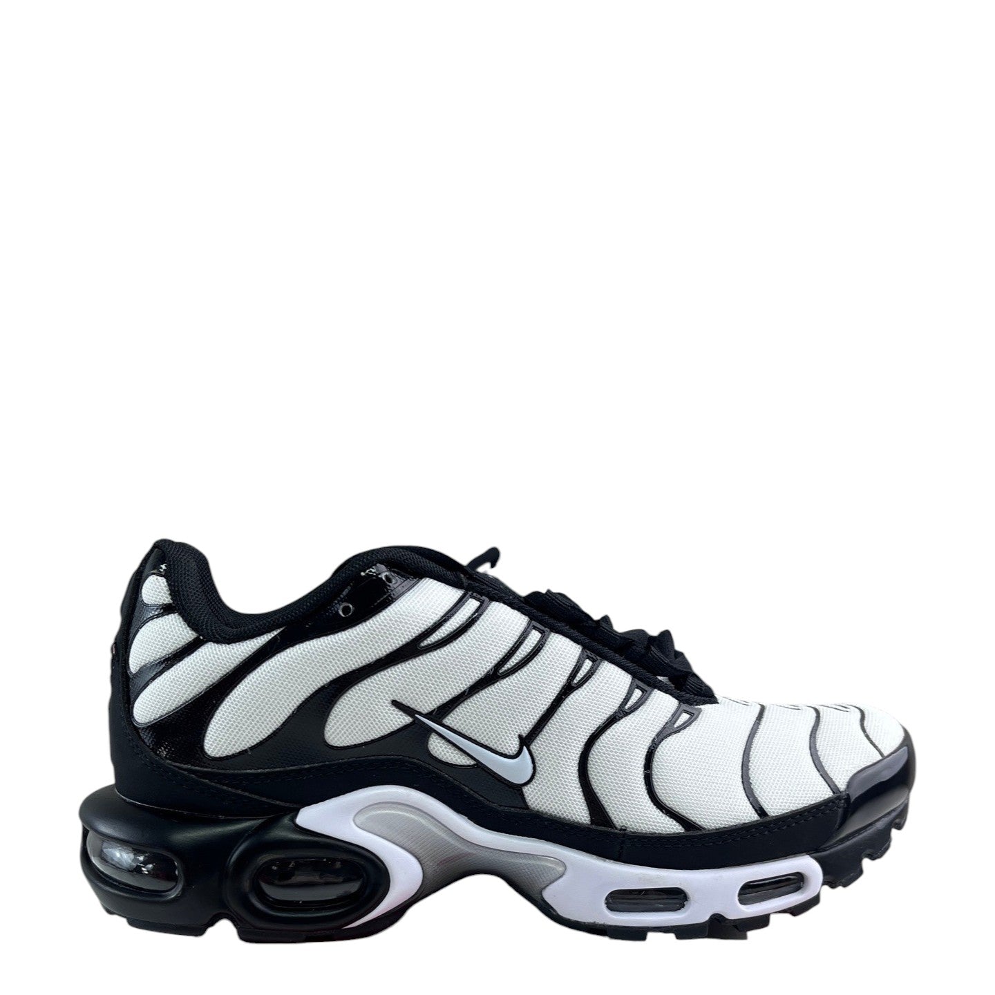 Luxury Chef Nike Air Max Plus TN sneakers in white, black, and grey with signature wavy overlays and visible air cushioning.