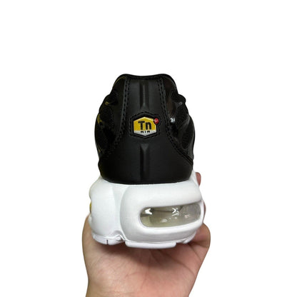 Luxury Chef Nike TN black sneakers with white sole and visible air cushioning. Features Tn Air logo.