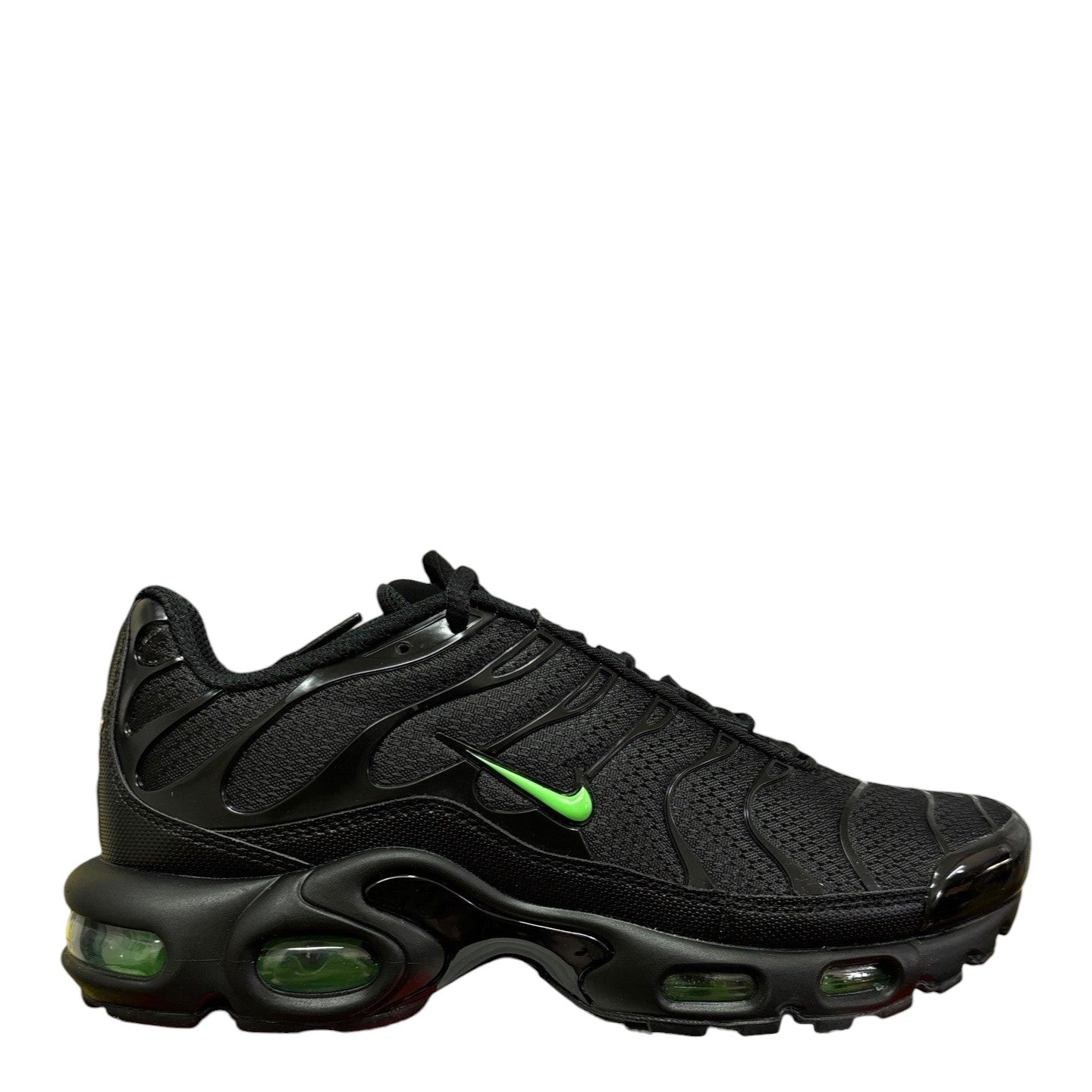 Luxury Chef Nike Air Max Plus TN sneakers in black with bright green accents and visible air cushioning.