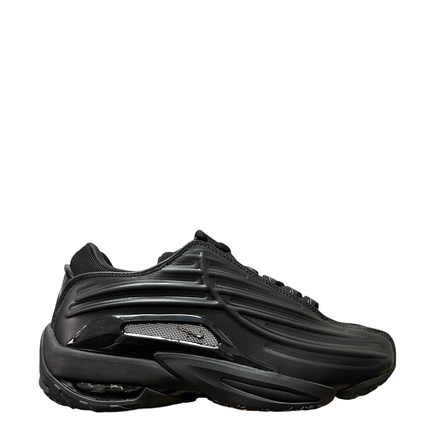 Luxury Chef NOCTA HOT STEP II black sneakers with metallic silver accents and cushioned sole.