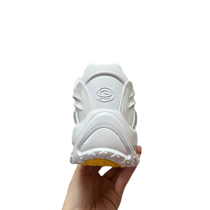 Luxury Chef NOCTA HOT STEP white leather sneakers with yellow sole and embossed logo detail.