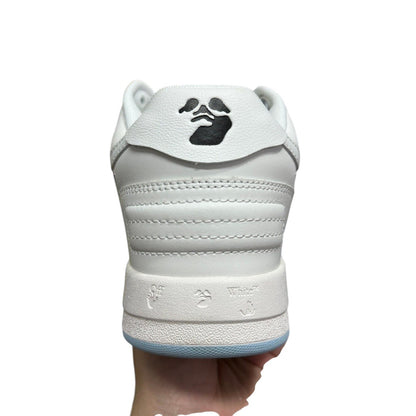 Luxury Chef Off-White Out of Office white leather sneakers with black logo detail and light blue sole.