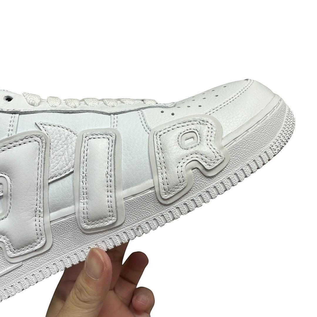 Luxury Chef white leather Air Force 1 CPFM sneakers with unique raised lettering details.