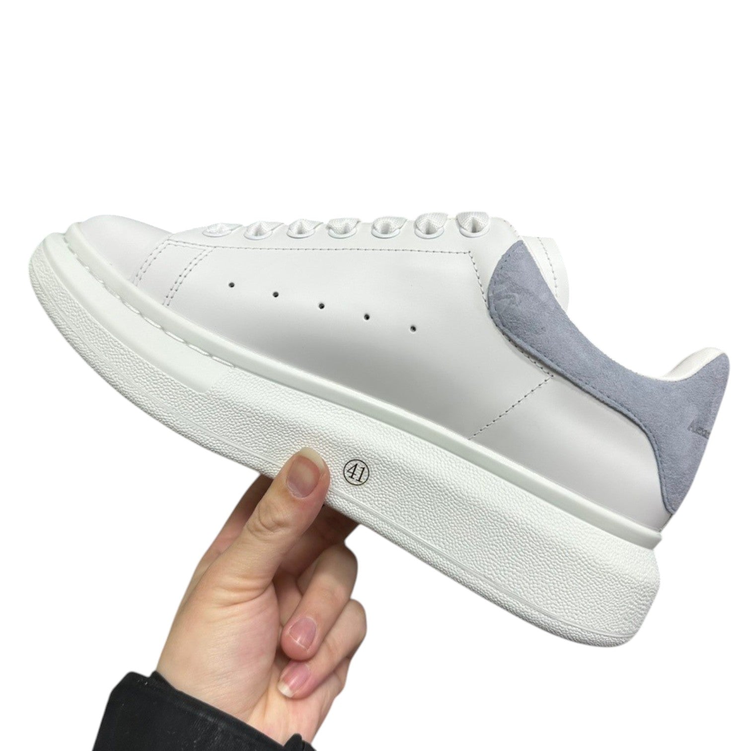 Luxury Chef white leather sneakers with light grey suede heel detail and thick white sole.