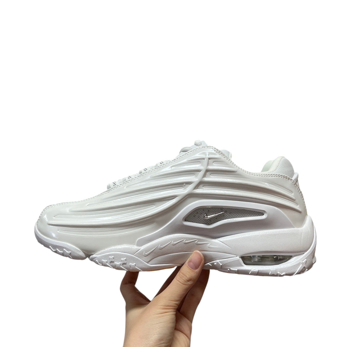 Luxury Chef NOCTA HOT STEP white leather sneakers with unique layered design and visible air cushioning.